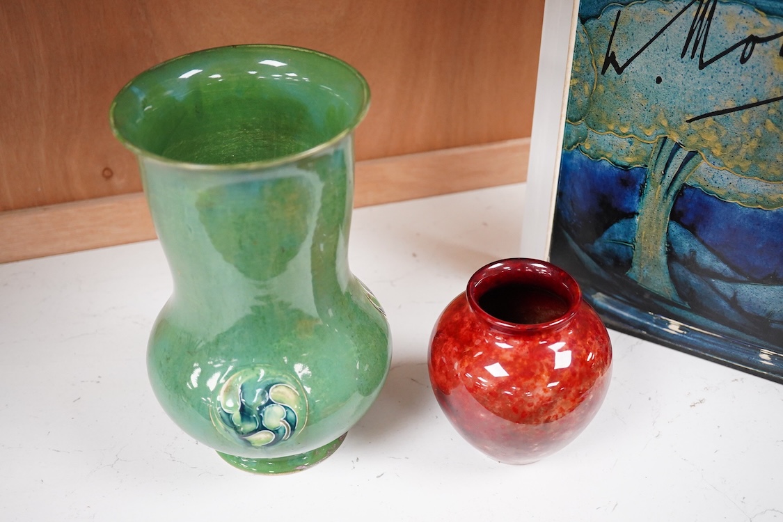 A Moorcroft for Liberty & Co. Flamminion Ware vase, and a smaller Moorcroft vase glazed in a mottled plum flambe, the first 20cm., also to include two Moorcroft reference books